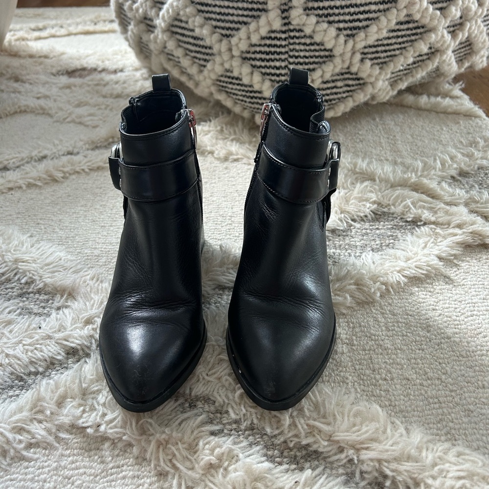 Black leather booties with silver details. Size 6.5
